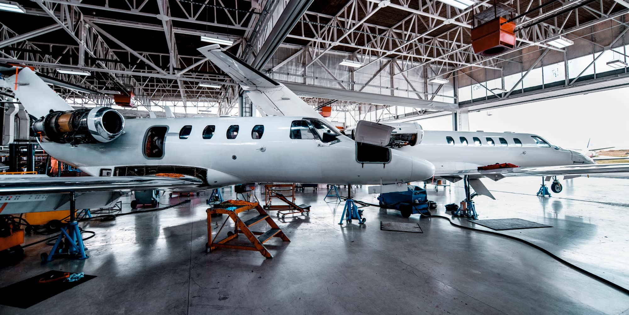 Airplanes being worked on in a hangar